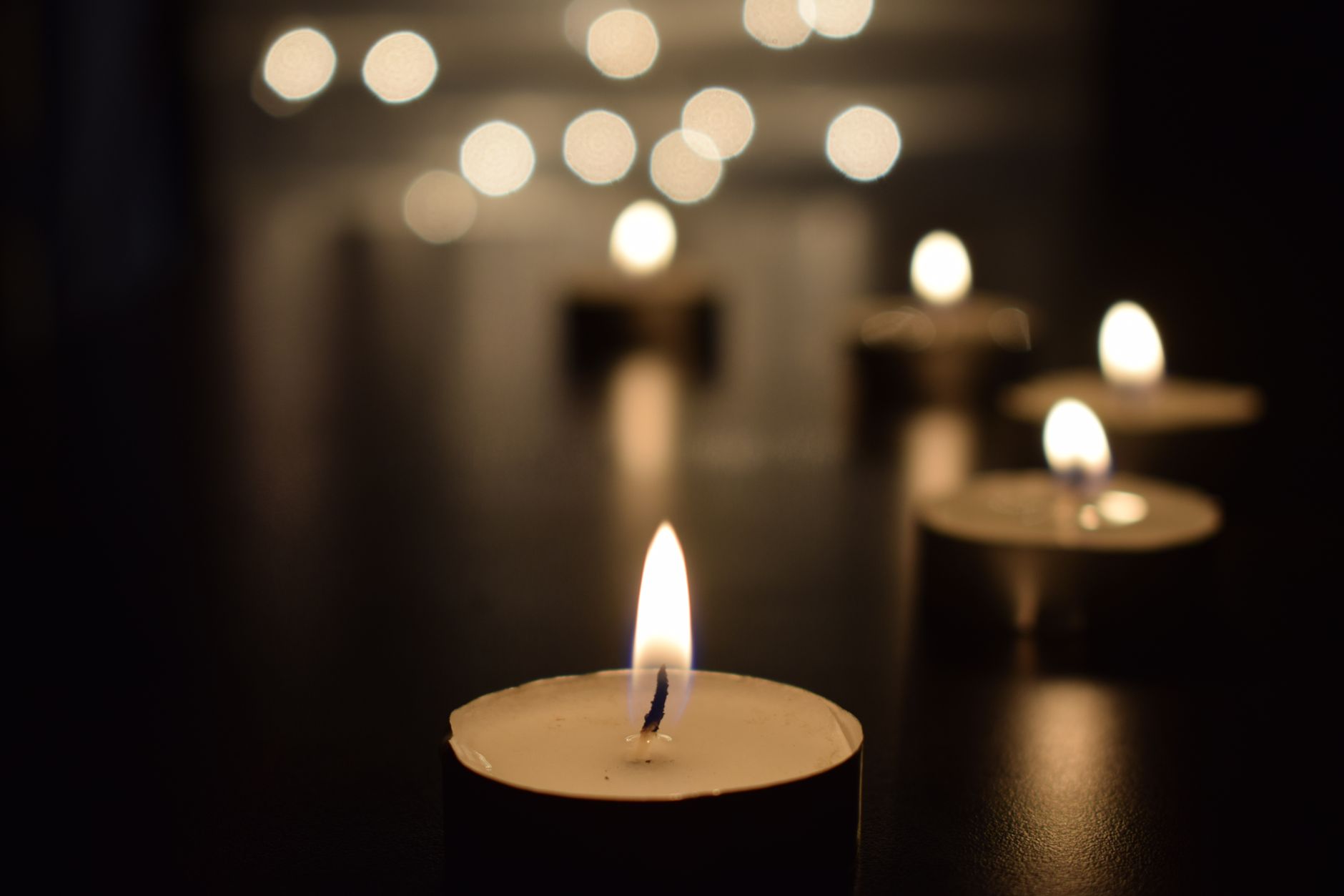 Warm and inviting candlelights creating a serene ambiance with a stunning bokeh effect.